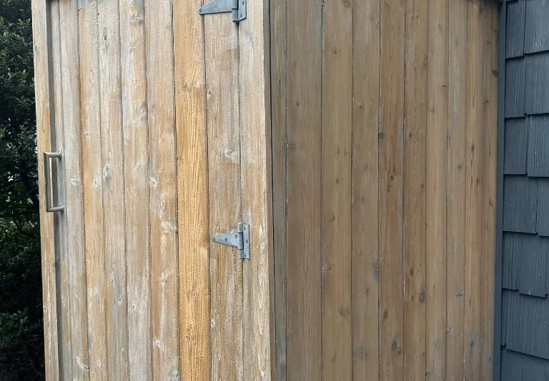 Weathered natural wood outdoor shower enclosure before staining